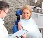 Dentist explaining cost of dental emergencies in Midlothian to patient