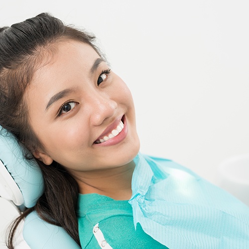 Close-up of female patient smiling in dental chair