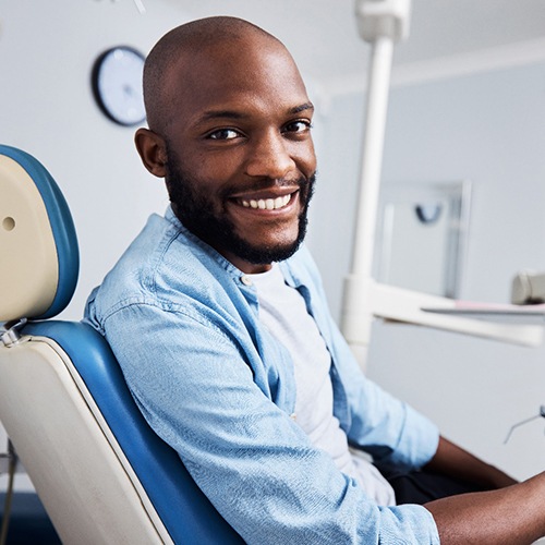 Bearded male patient smiling in dental chair