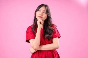 Young woman wearing curious, thoughtful expression